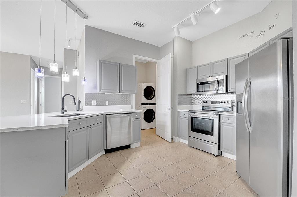617 Terrace Ridge Circle, Unit 617 Davenport, FL 33896 - Photo 27 of 40 a kitchen with cabinets and stainless steel appliances