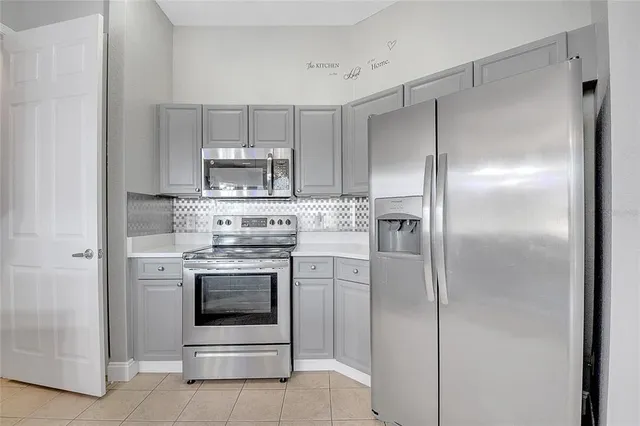 a kitchen with cabinets and stainless steel appliances