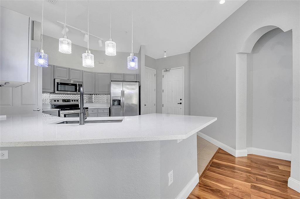 617 Terrace Ridge Circle, Unit 617 Davenport, FL 33896 - Photo 5 of 40 a kitchen with cabinets and wooden floor