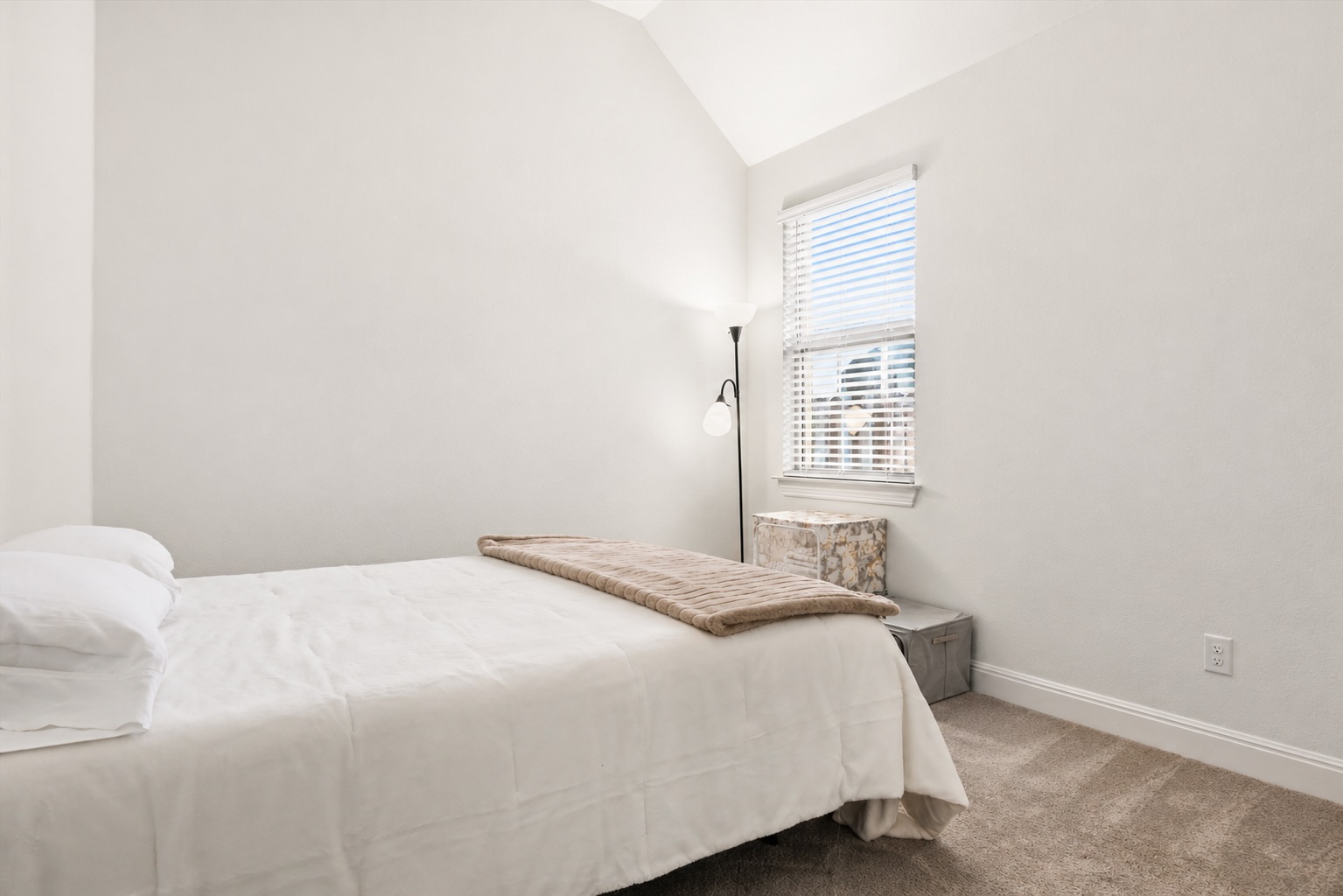 209 Rainier Drive Kyle, TX 78640 - Photo 14 of 24 Vaulted ceiling bedroom featuring a single window with blinds, light-colored walls, and carpet flooring