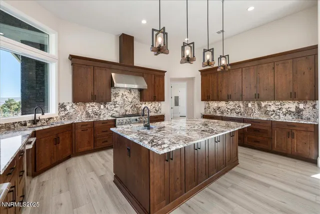 a kitchen with granite countertop a sink and a stove