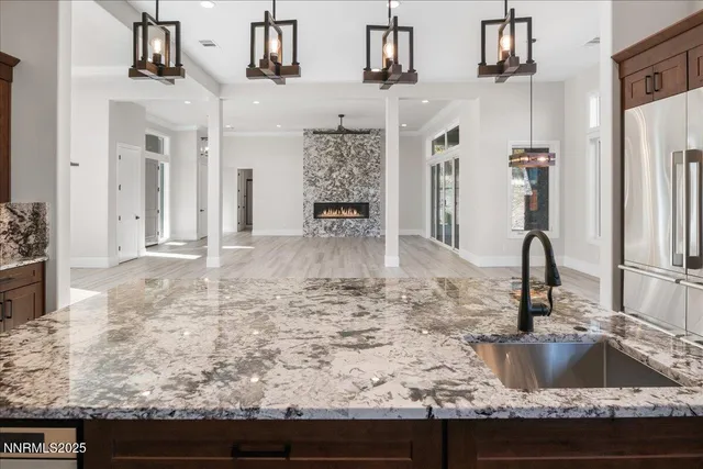 a kitchen with stainless steel appliances granite countertop a sink stove and cabinets