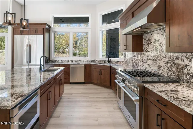 a kitchen with stainless steel appliances granite countertop a stove and a sink
