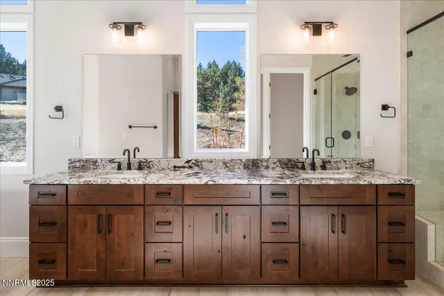 a bathroom with a shower sink and mirror