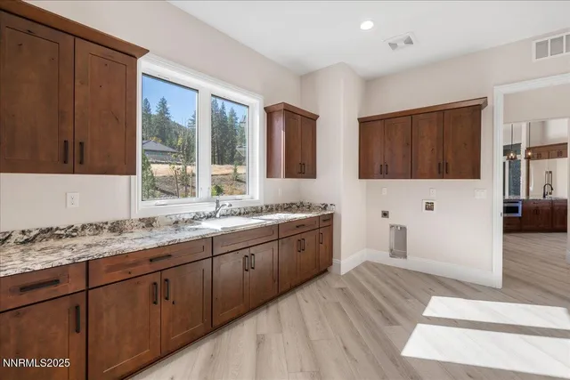 a bathroom with a granite countertop sink and a large mirror