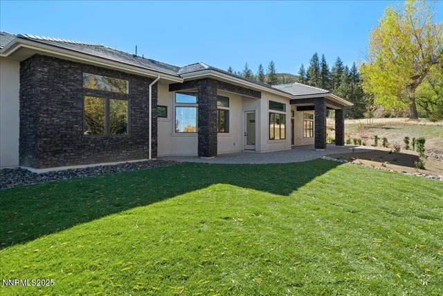 a view of a house with a swimming pool and a yard