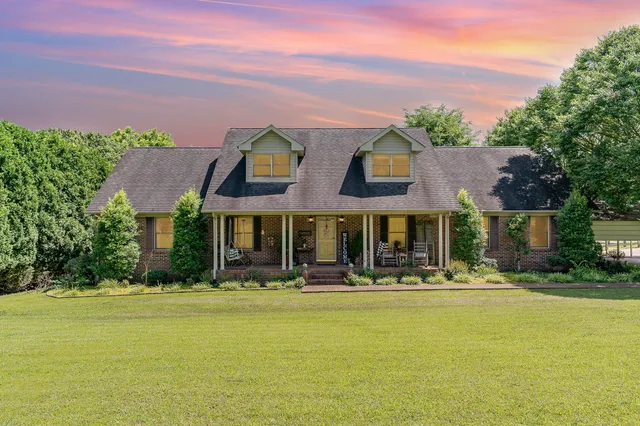 a front view of building with yard and green space