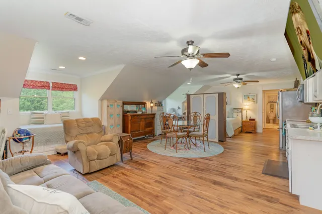 a living room with furniture a fireplace and a chandelier