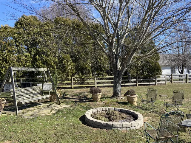 a view of swimming pool with a yard and sitting area