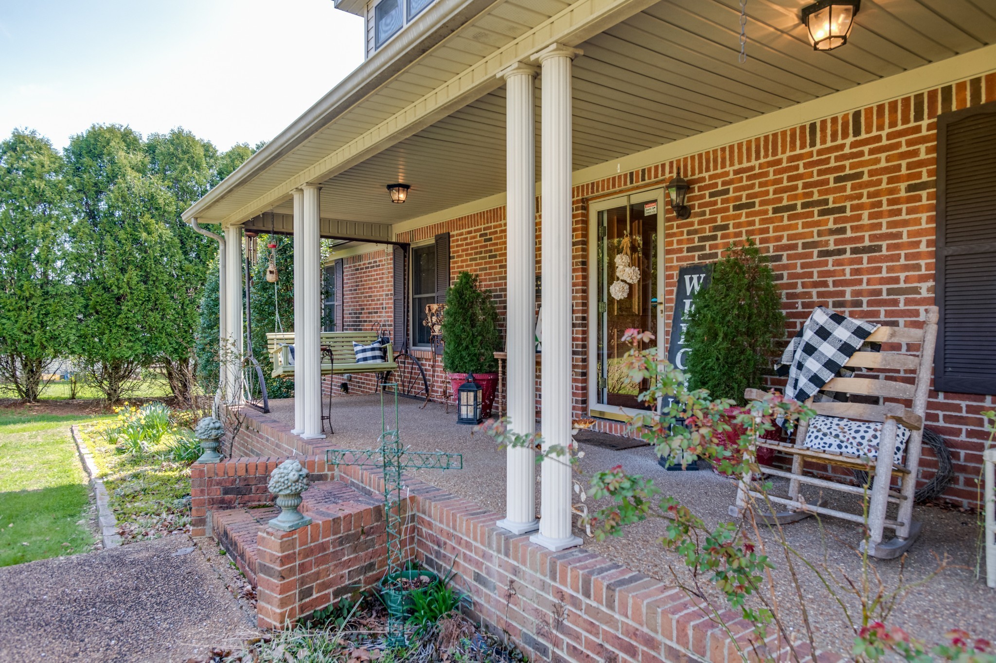4360 Scott Hollow Road Culleoka, TN 38451 - Photo 3 of 27 a view of a patio with couches table and chairs with plants and garden