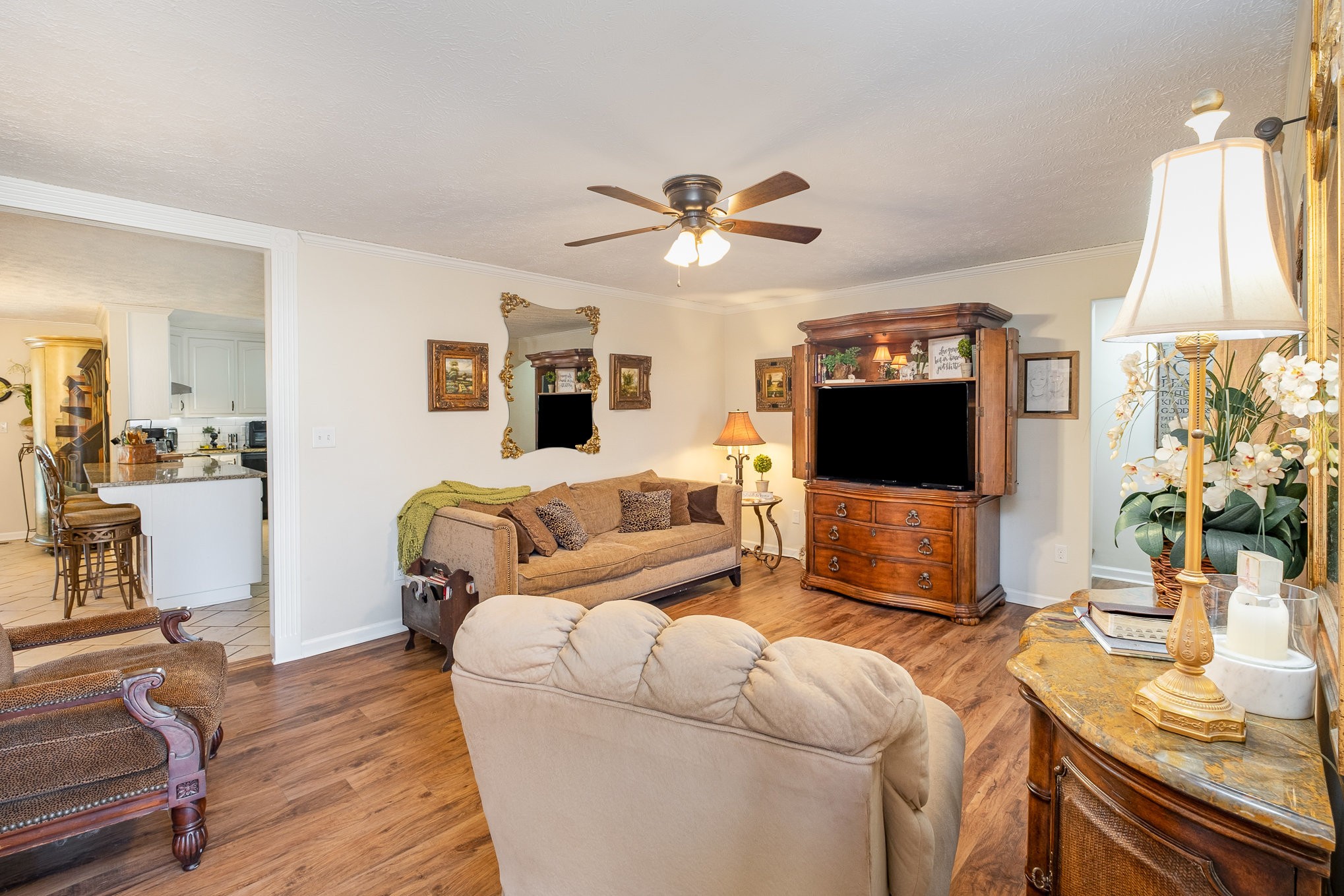 4360 Scott Hollow Road Culleoka, TN 38451 - Photo 8 of 27 a living room with furniture a flat screen tv and a chandelier
