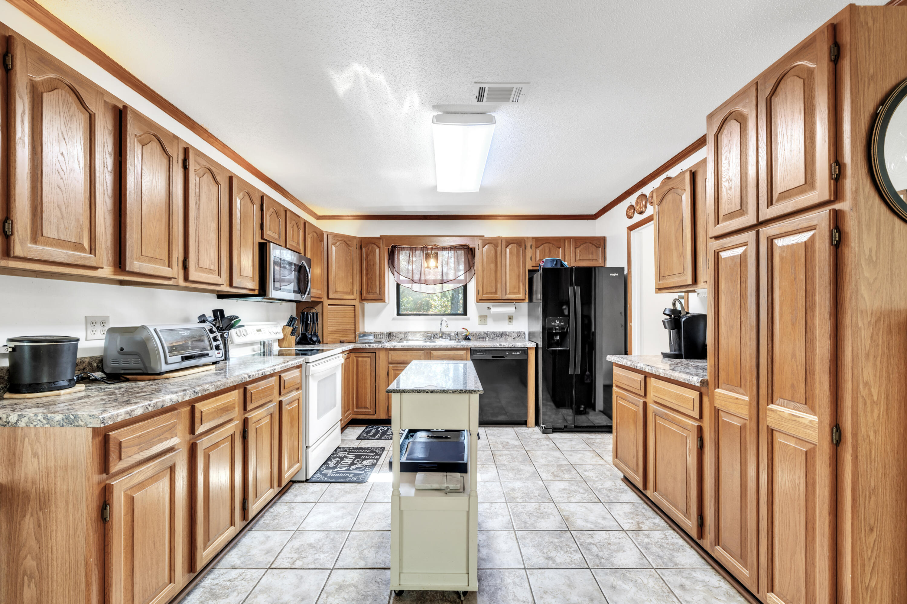 32 Walnut Avenue Shalimar, FL 32579 - Photo 14 of 56 a kitchen with stainless steel appliances granite countertop a refrigerator and cabinets