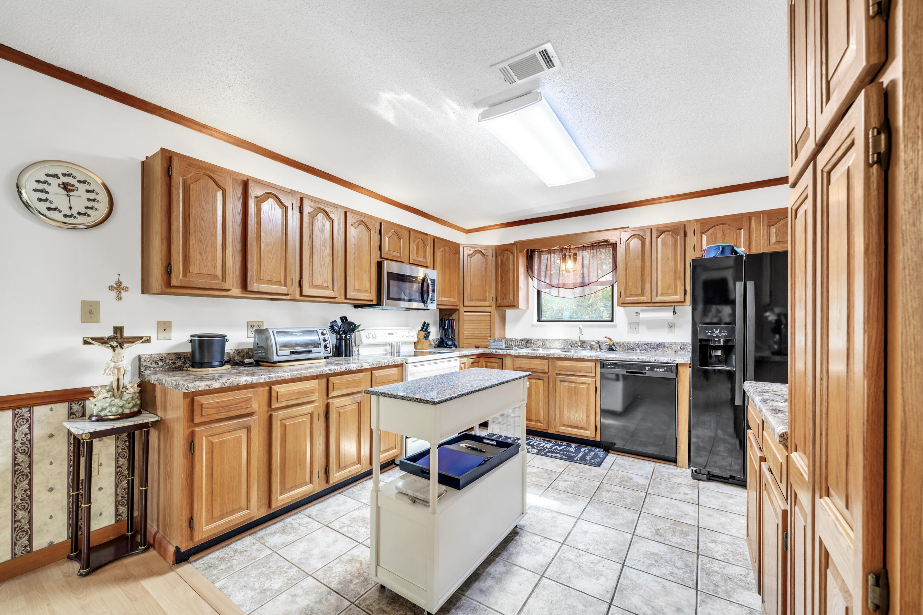 32 Walnut Avenue Shalimar, FL 32579 - Photo 15 of 56 a kitchen with a sink stove top oven and cabinets