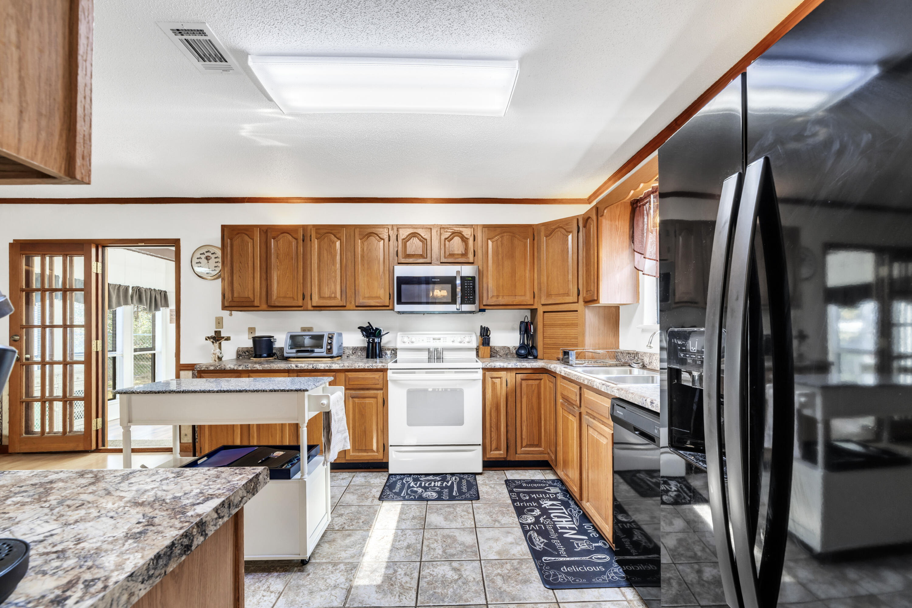 32 Walnut Avenue Shalimar, FL 32579 - Photo 16 of 56 a kitchen with stainless steel appliances granite countertop a refrigerator and stove