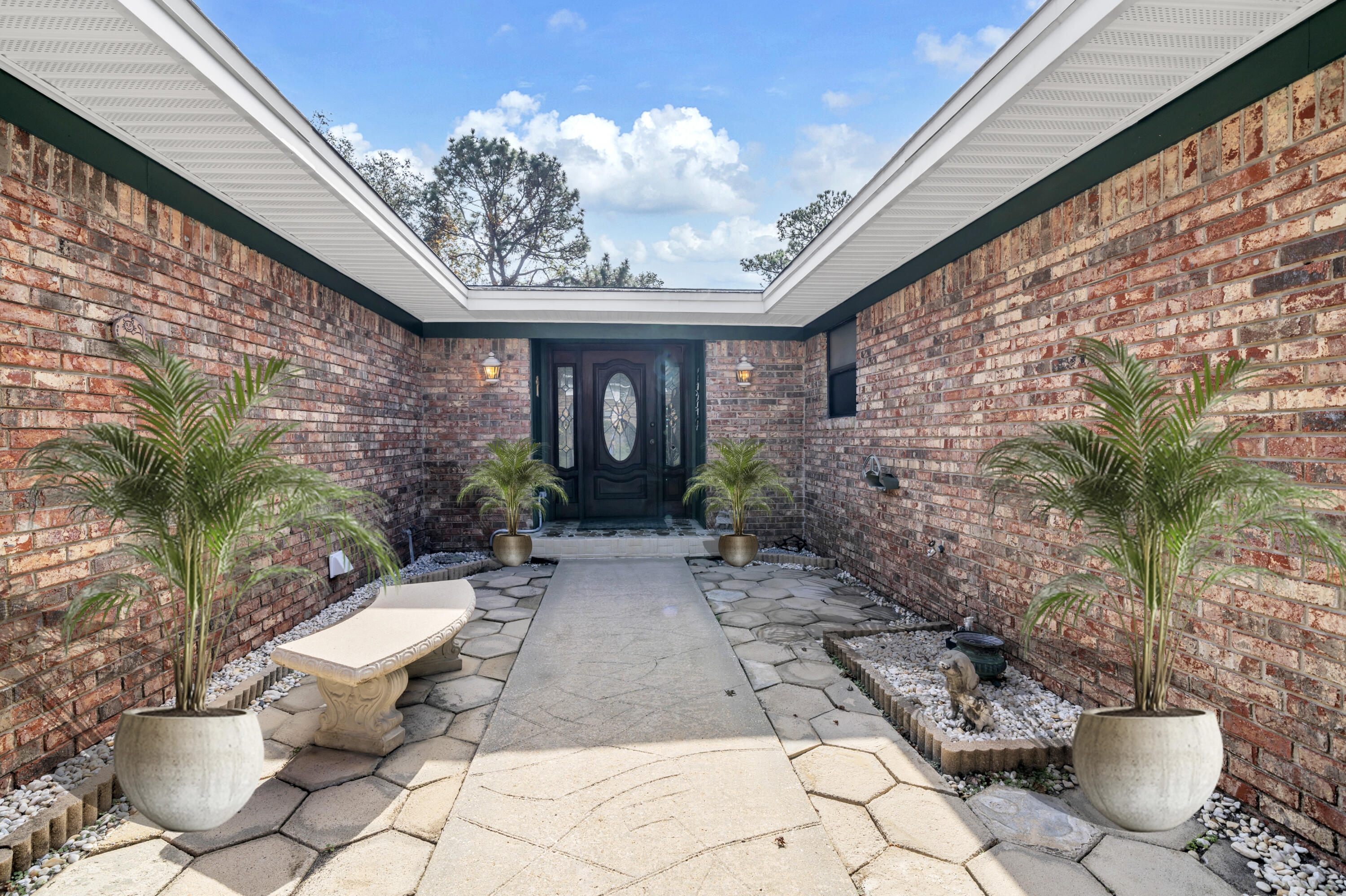 32 Walnut Avenue Shalimar, FL 32579 - Photo 2 of 56 a view of a backyard with plants and a patio