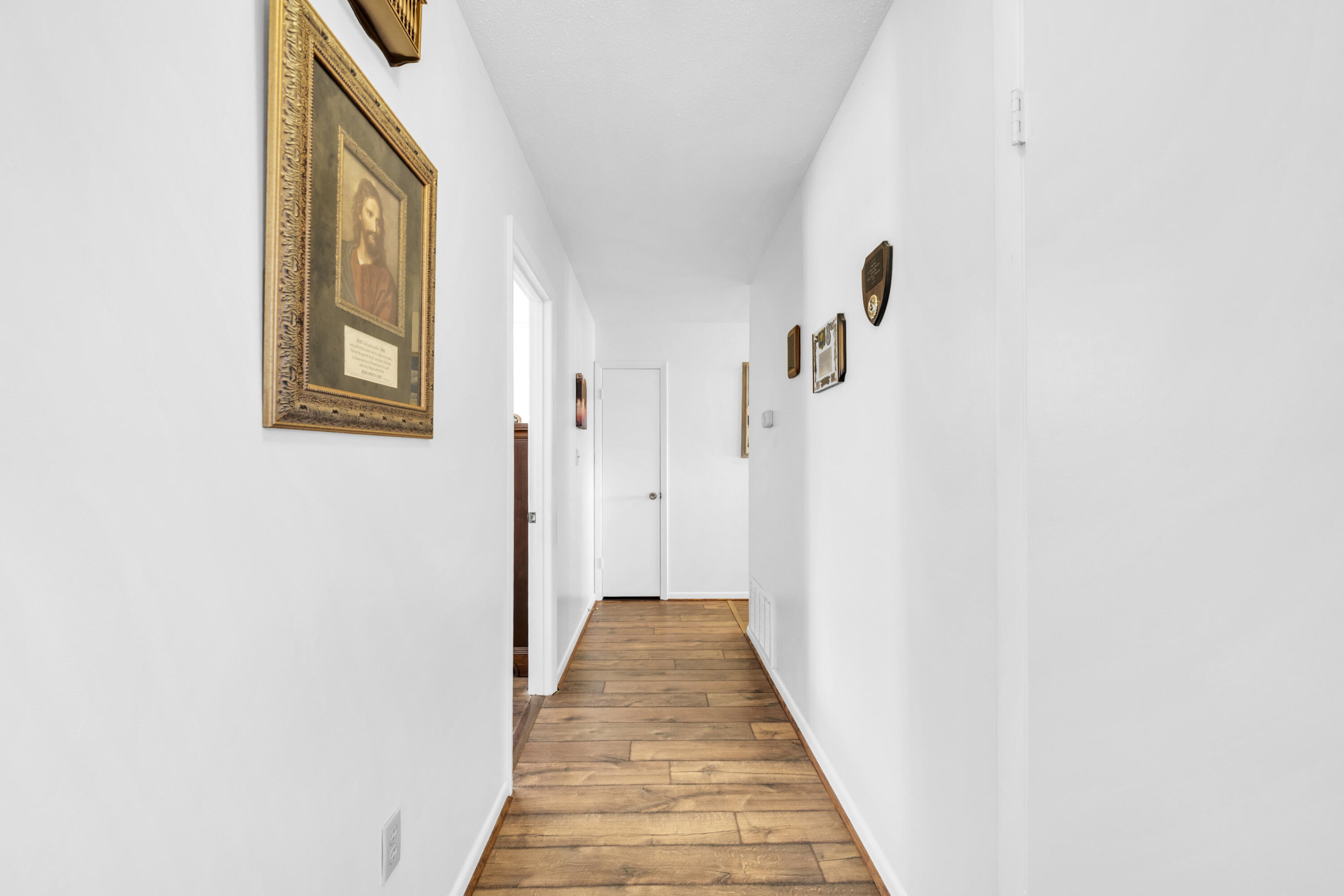 32 Walnut Avenue Shalimar, FL 32579 - Photo 27 of 56 a view of a hallway with wooden floor and staircase