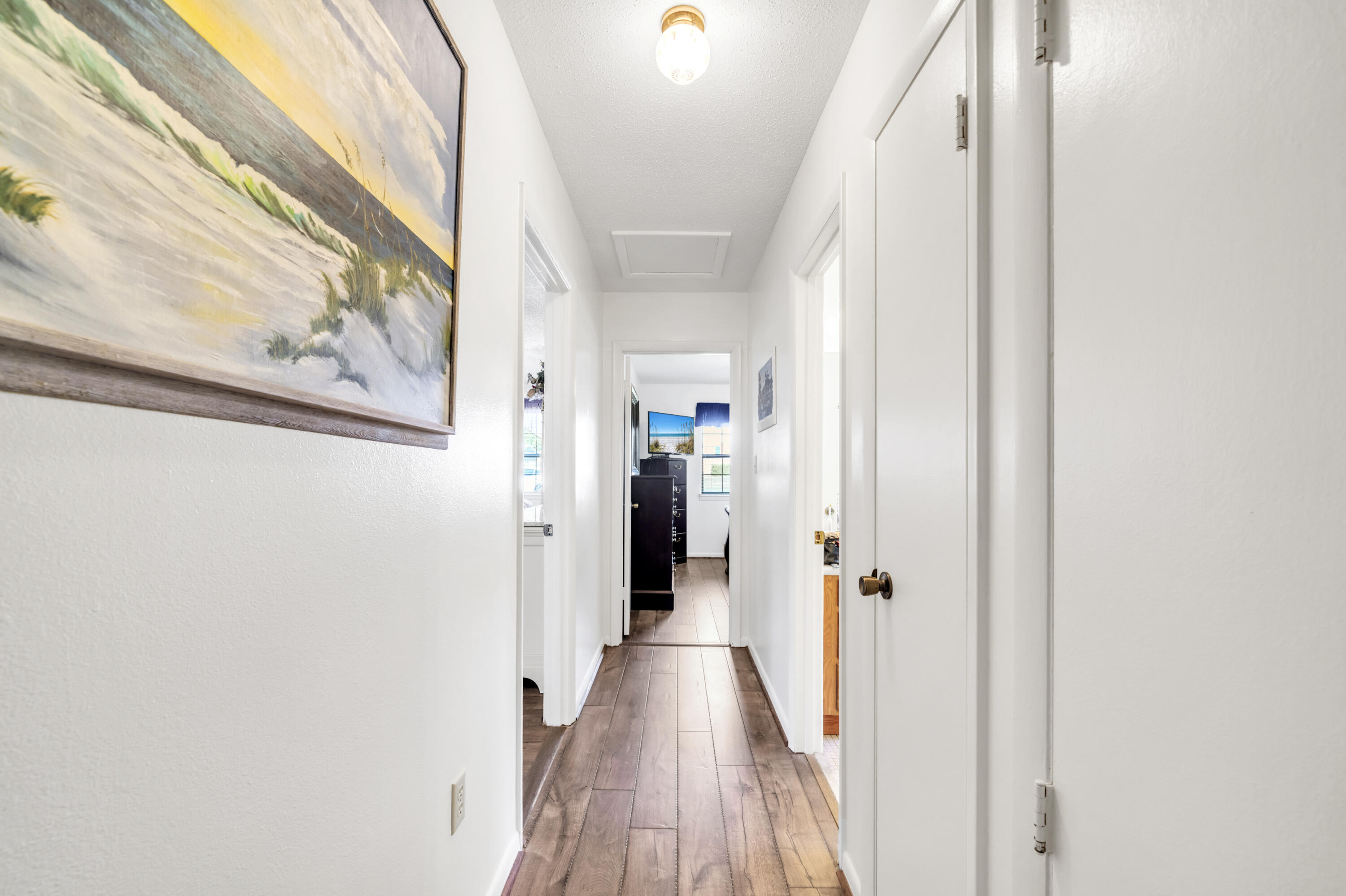 32 Walnut Avenue Shalimar, FL 32579 - Photo 30 of 56 a view of a hallway with wooden floor and stairs