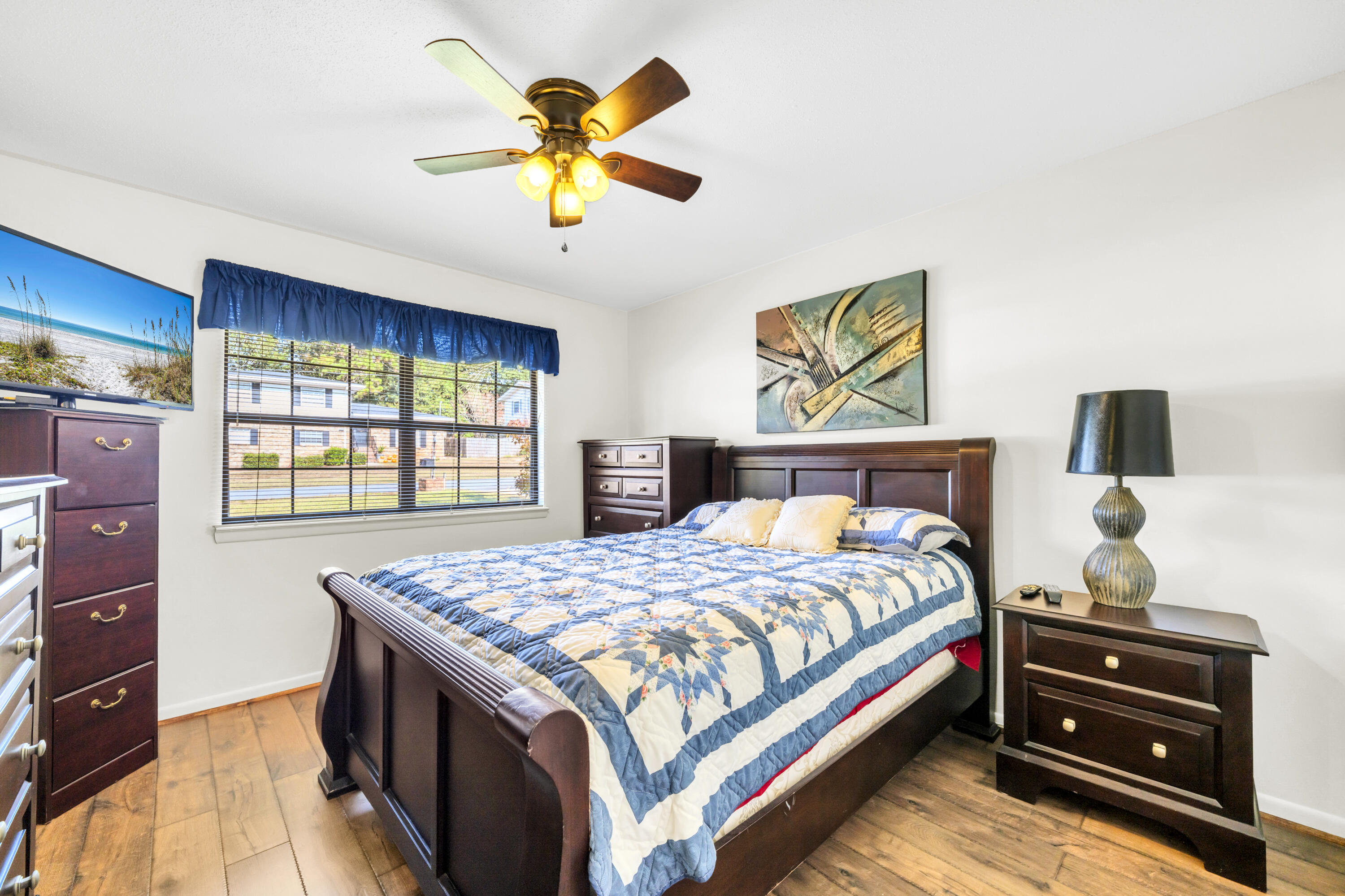 32 Walnut Avenue Shalimar, FL 32579 - Photo 31 of 56 a bedroom with a bed and a chandelier