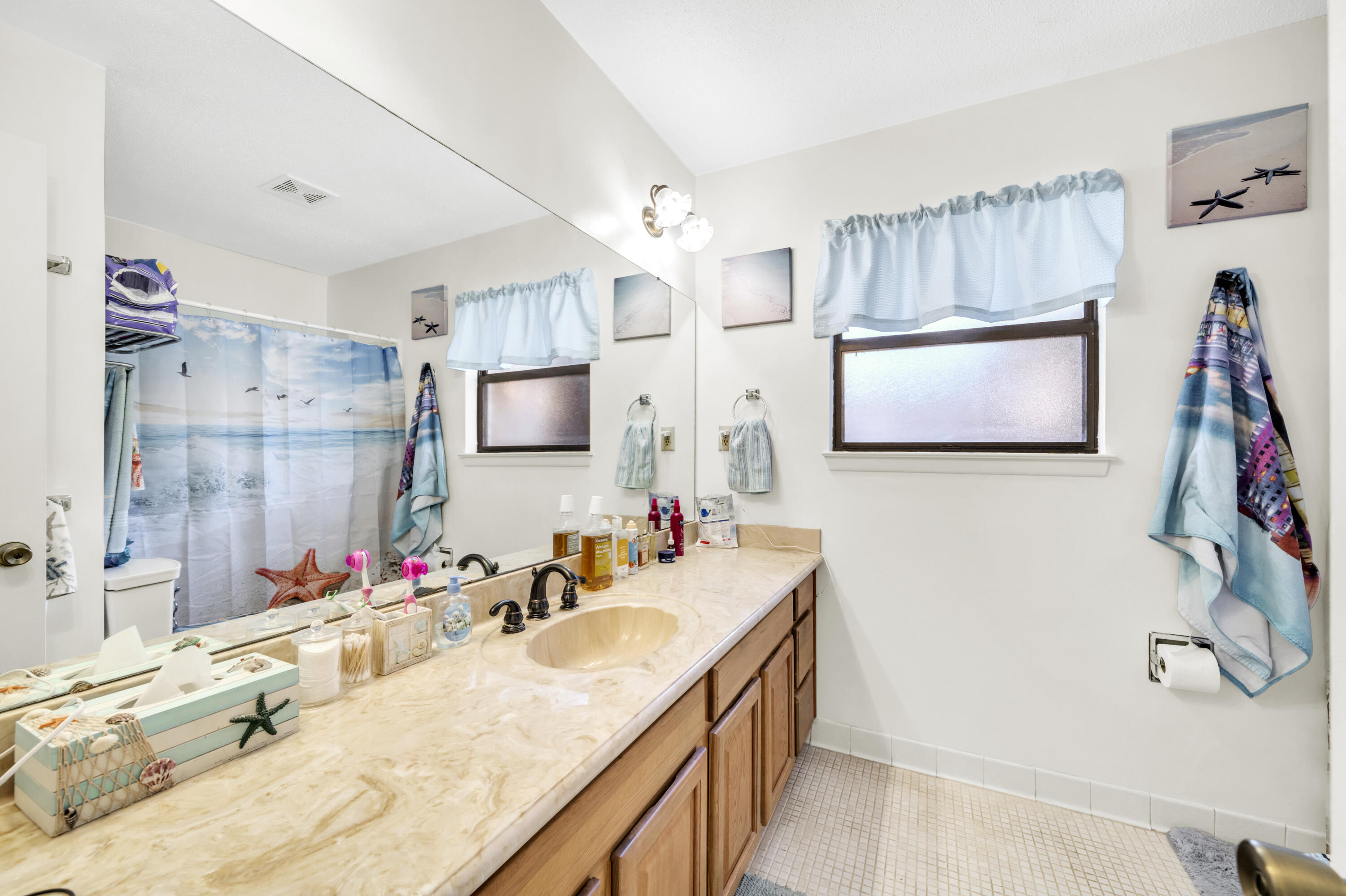 32 Walnut Avenue Shalimar, FL 32579 - Photo 33 of 56 a bathroom with a tub sink and mirror