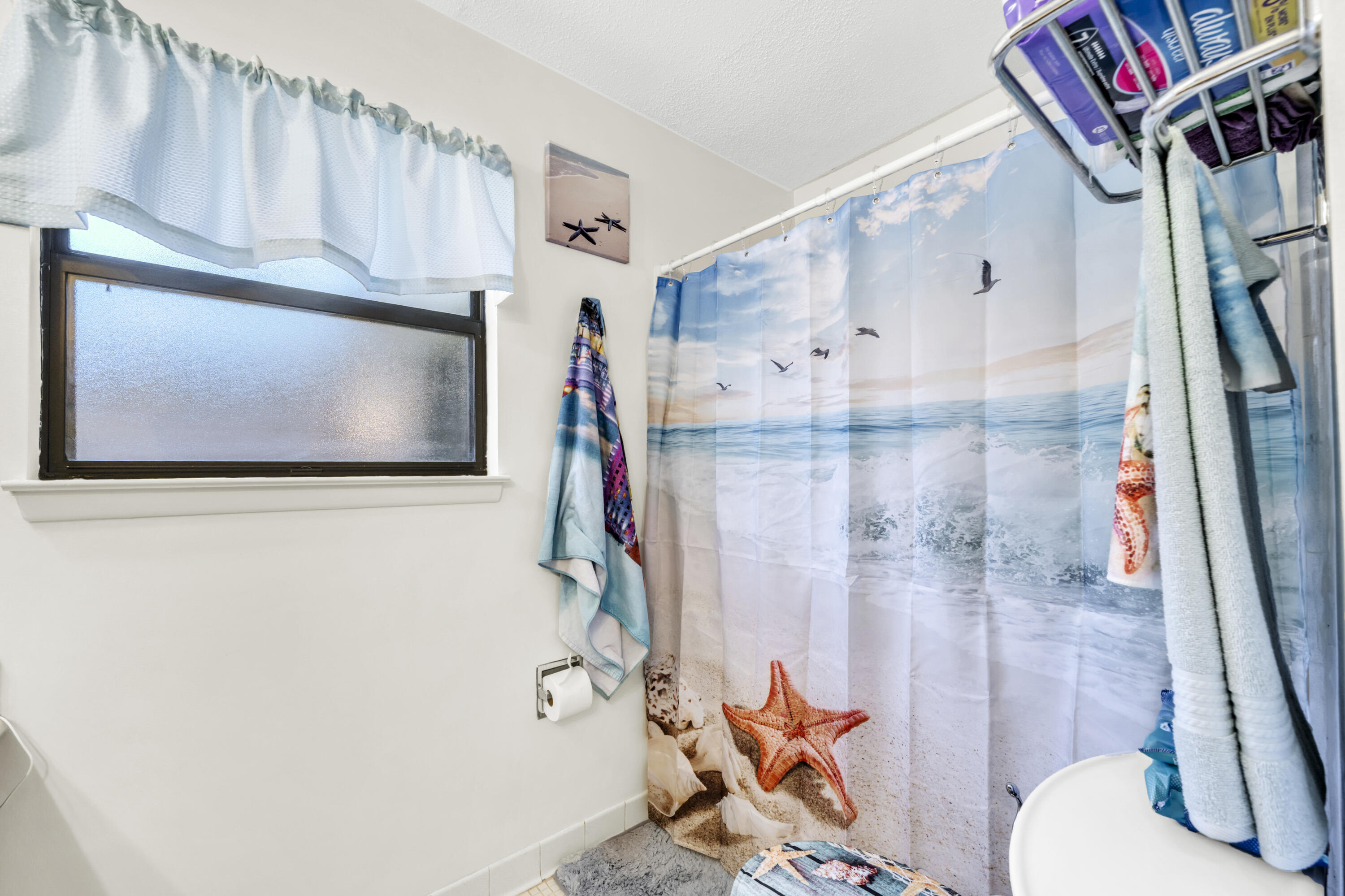 32 Walnut Avenue Shalimar, FL 32579 - Photo 34 of 56 a bathroom with a granite countertop sink a toilet and a shower curtain
