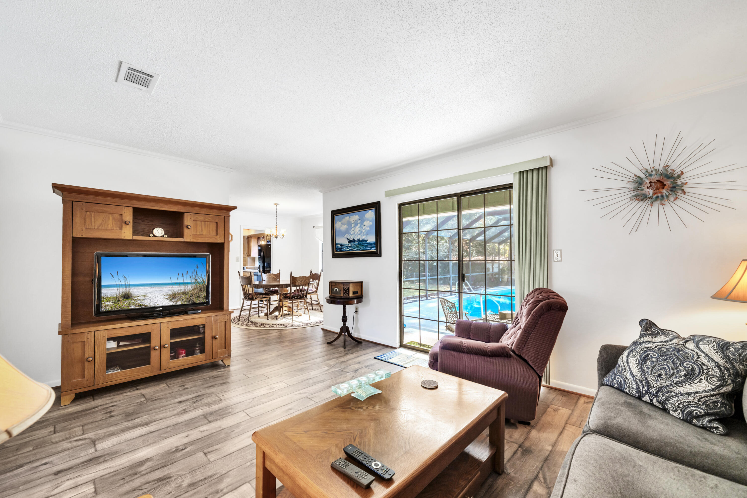 32 Walnut Avenue Shalimar, FL 32579 - Photo 9 of 56 a living room with furniture a flat screen tv and wooden floor