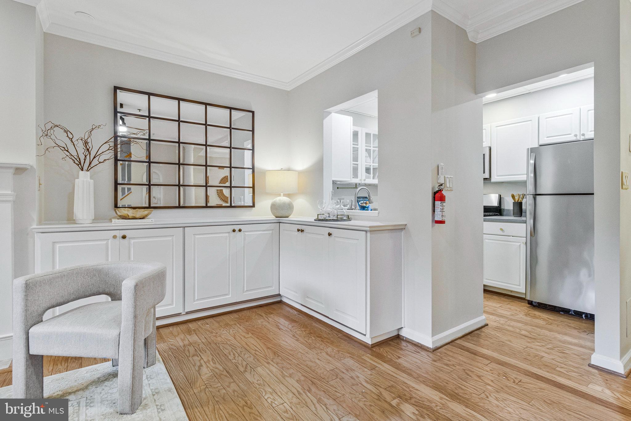 2413 20th Street Northwest, Unit 1 Washington, DC 20009 - Photo 15 of 31 a kitchen with white cabinets and wooden floor