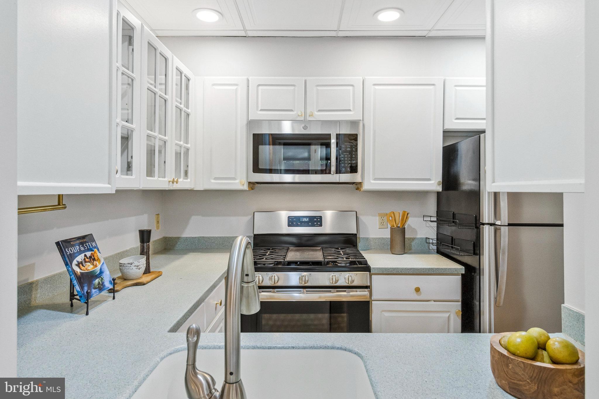 2413 20th Street Northwest, Unit 1 Washington, DC 20009 - Photo 16 of 31 a kitchen with stainless steel appliances a stove a microwave and refrigerator