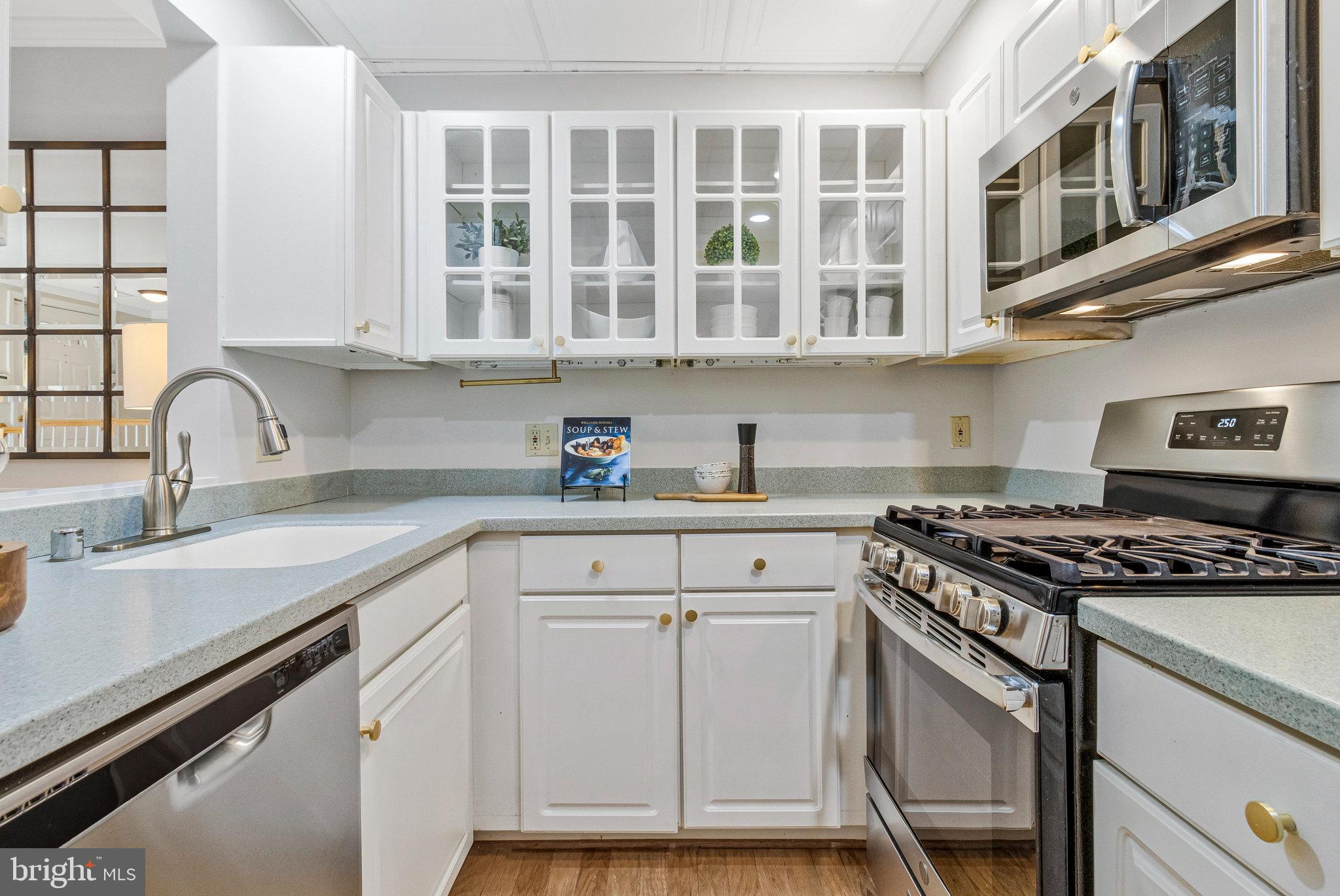 2413 20th Street Northwest, Unit 1 Washington, DC 20009 - Photo 17 of 31 a kitchen with stainless steel appliances granite countertop a sink stove and cabinets