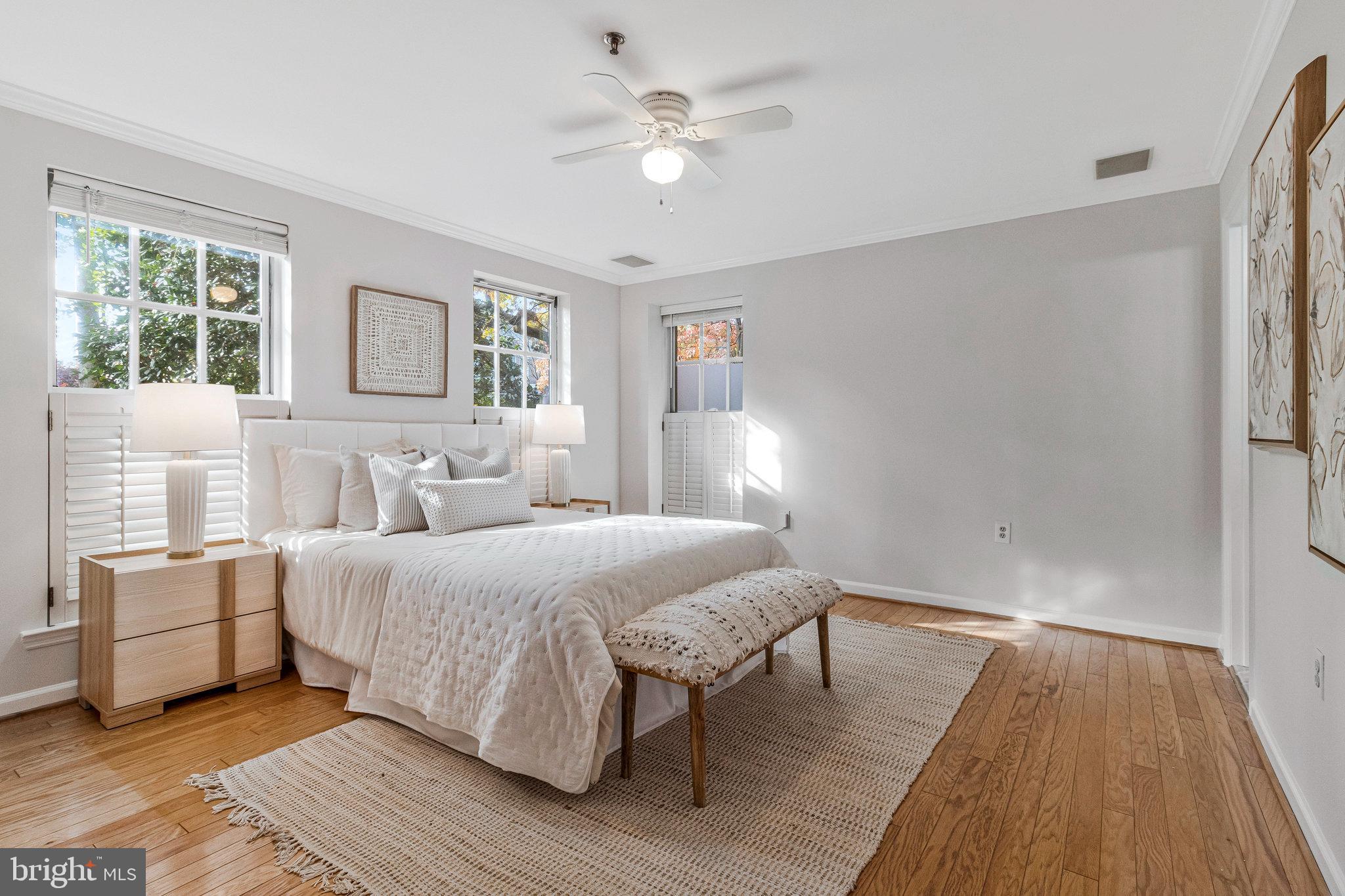 2413 20th Street Northwest, Unit 1 Washington, DC 20009 - Photo 23 of 31 a spacious bedroom with a bed and a chandelier