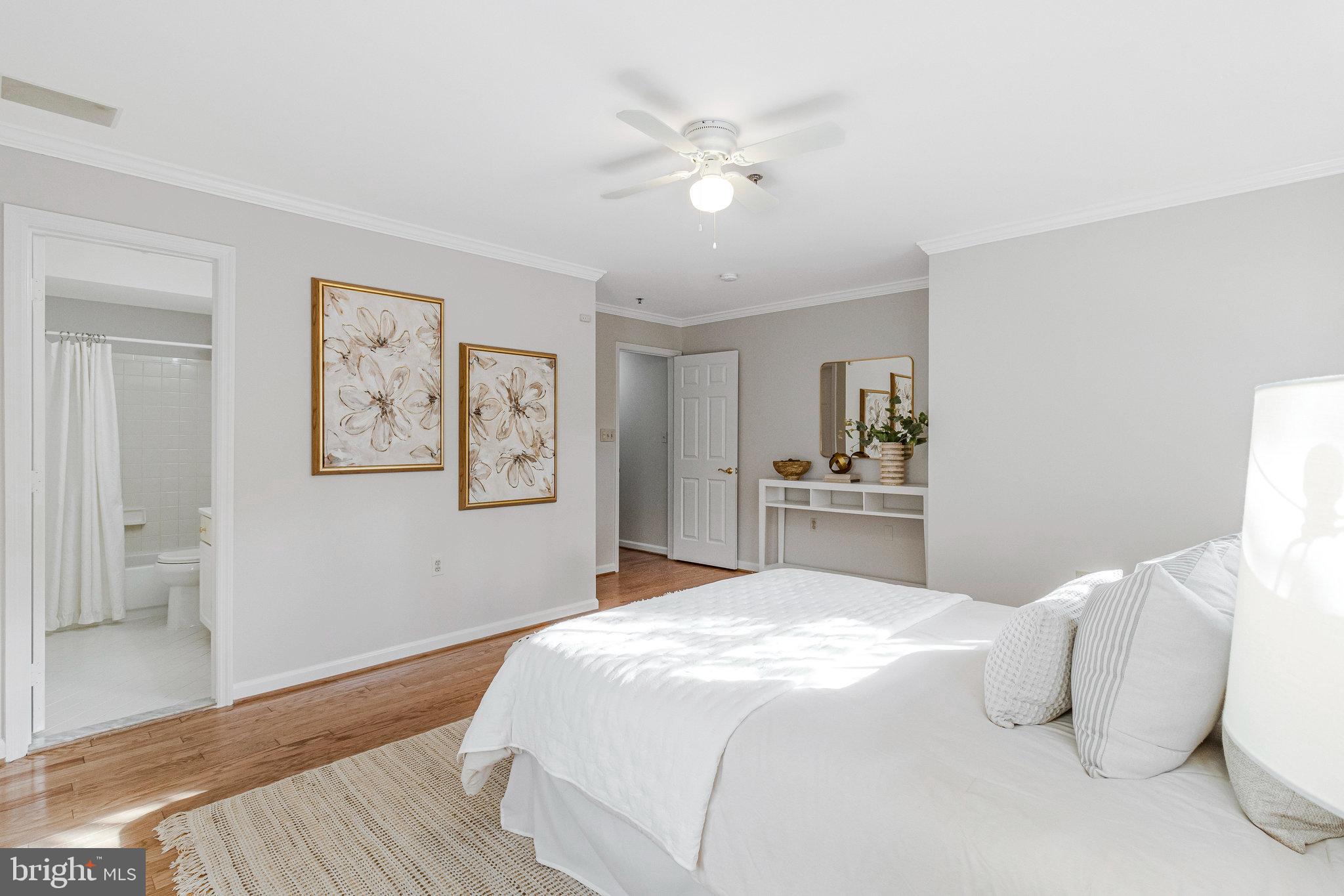 2413 20th Street Northwest, Unit 1 Washington, DC 20009 - Photo 24 of 31 a bedroom with a white bed and a chandelier