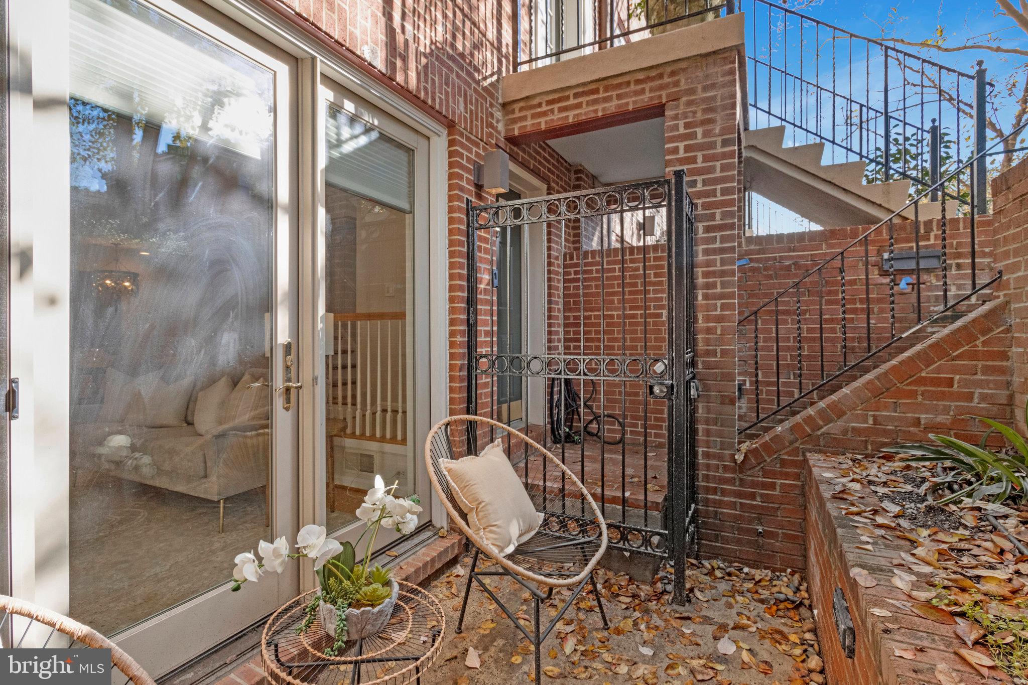 2413 20th Street Northwest, Unit 1 Washington, DC 20009 - Photo 30 of 31 a patio with table and chairs and potted plants