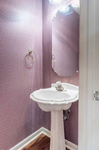 a bathroom with a sink a mirror and toilet