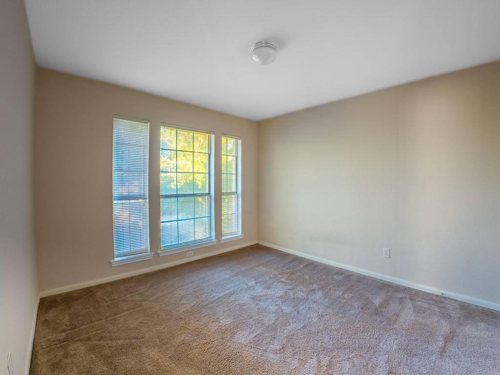 1706 Apache Trail Round Rock, TX 78665 - Photo 27 of 40 Carpeted empty room featuring baseboards