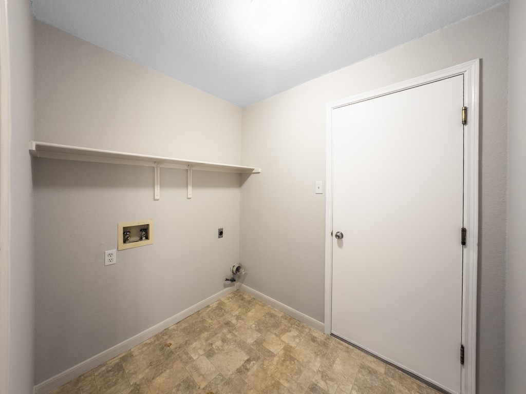 1706 Apache Trail Round Rock, TX 78665 - Photo 31 of 40 Laundry area with electric dryer hookup, hookup for a washing machine, and stone finish flooring