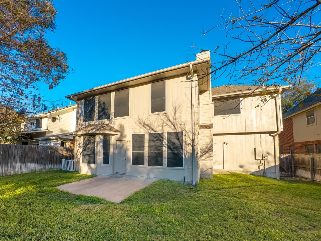 1706 Apache Trail Round Rock, TX 78665 - Photo 35 of 40 Back of property with a chimney and a patio