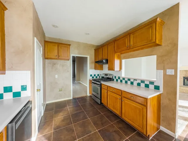 a kitchen with stainless steel appliances a sink stove and refrigerator