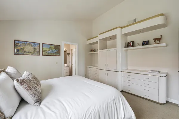 a bedroom with a bed and a cabinets