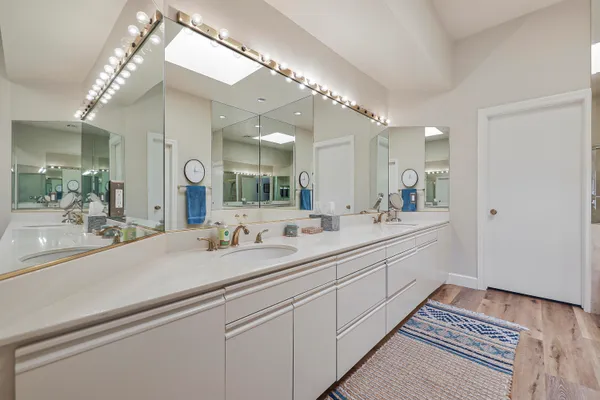 a spacious bathroom with a double vanity sink and a mirror