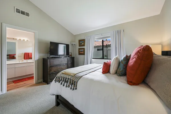 a bedroom with a large bed and a tv