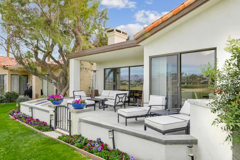 a building outdoor space with patio furniture and garden