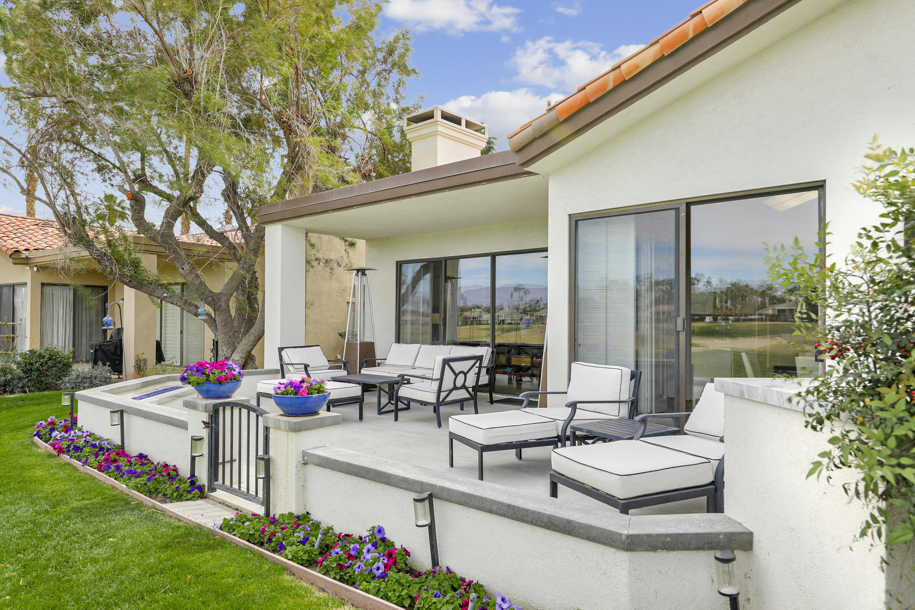 54721 Inverness Way La Quinta, CA 92253 - Photo 35 of 52 a building outdoor space with patio furniture and garden