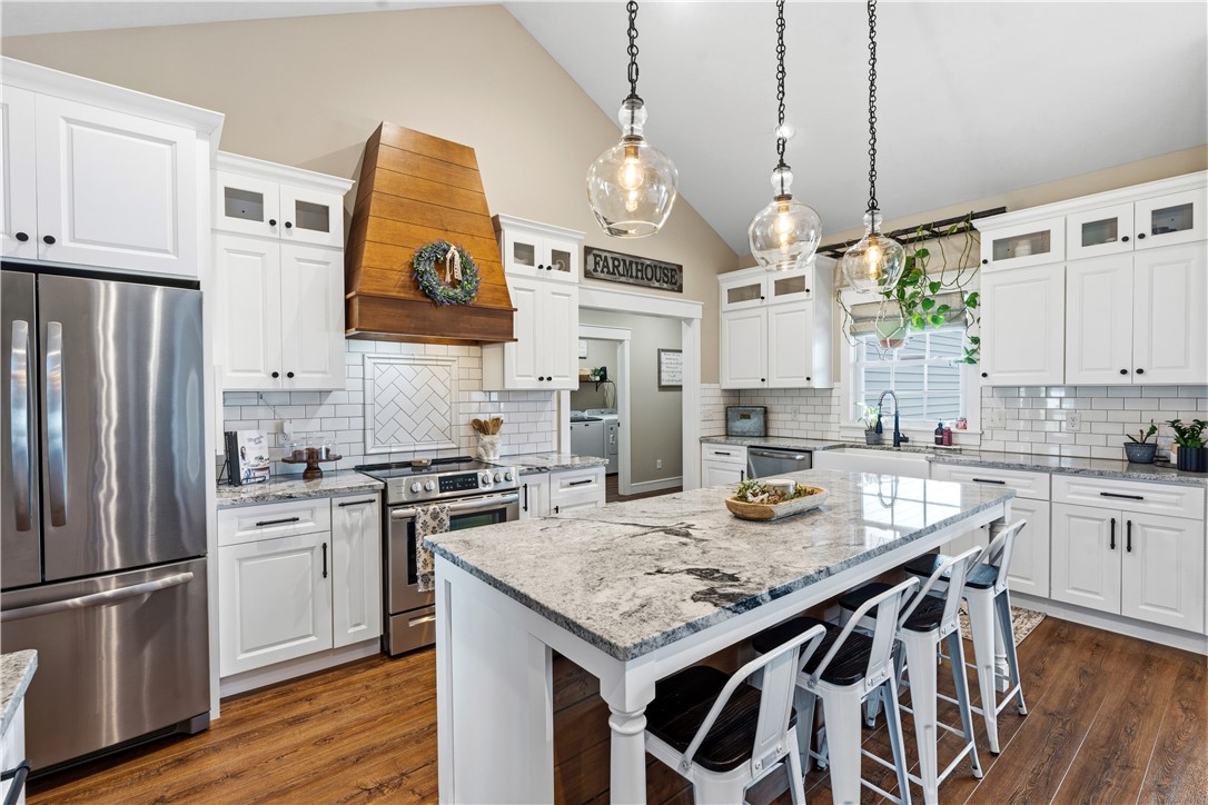 1158 Pyle Road Clarksville, OH 45113 - Photo 20 of 76 This spacious kitchen offers a beautiful kitchen island, white cabinets, and stainless steel appliances.