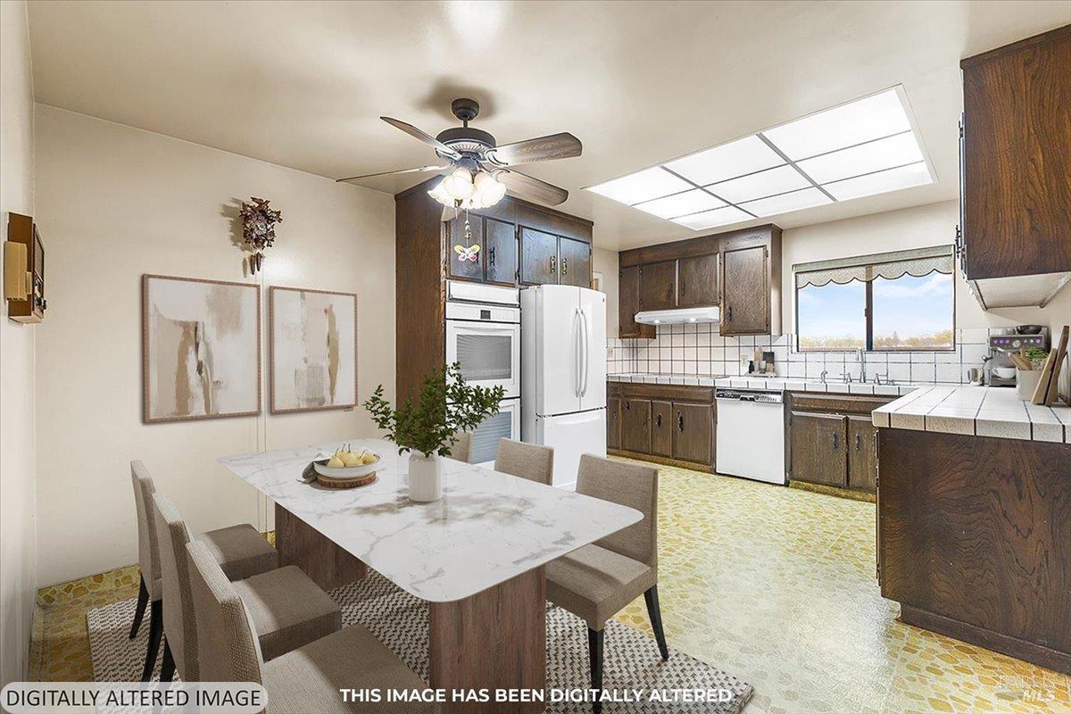 2062 Woolsey Road Fulton, CA 95439 - Photo 12 of 44 a kitchen with a table chairs microwave and cabinets