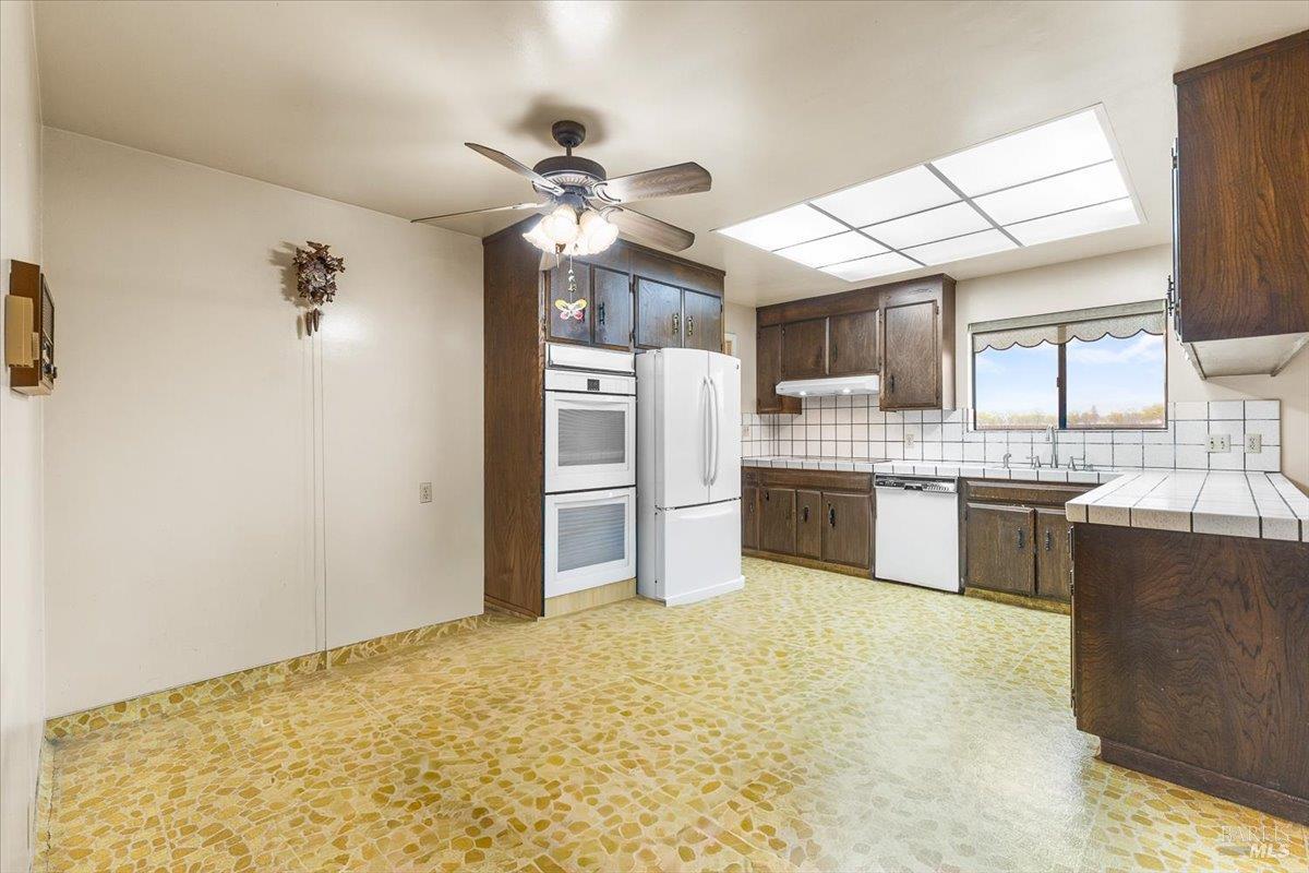 2062 Woolsey Road Fulton, CA 95439 - Photo 13 of 44 a large kitchen with cabinets and stainless steel appliances