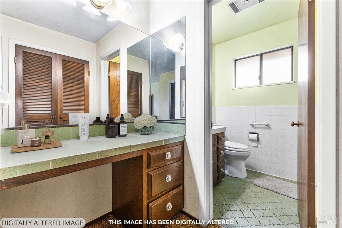 2062 Woolsey Road Fulton, CA 95439 - Photo 20 of 44 a bathroom with a granite countertop sink a toilet and a mirror