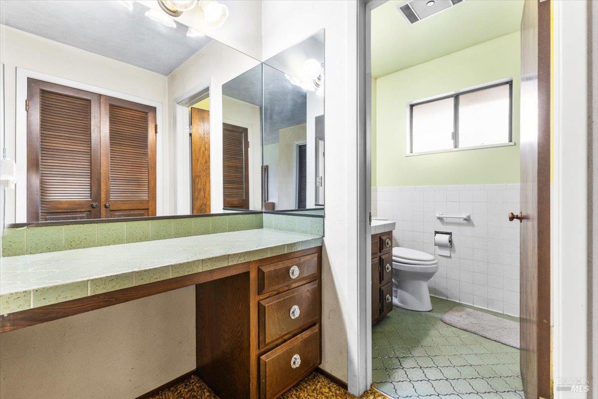 2062 Woolsey Road Fulton, CA 95439 - Photo 21 of 44 a bathroom with a toilet a sink and a large mirror
