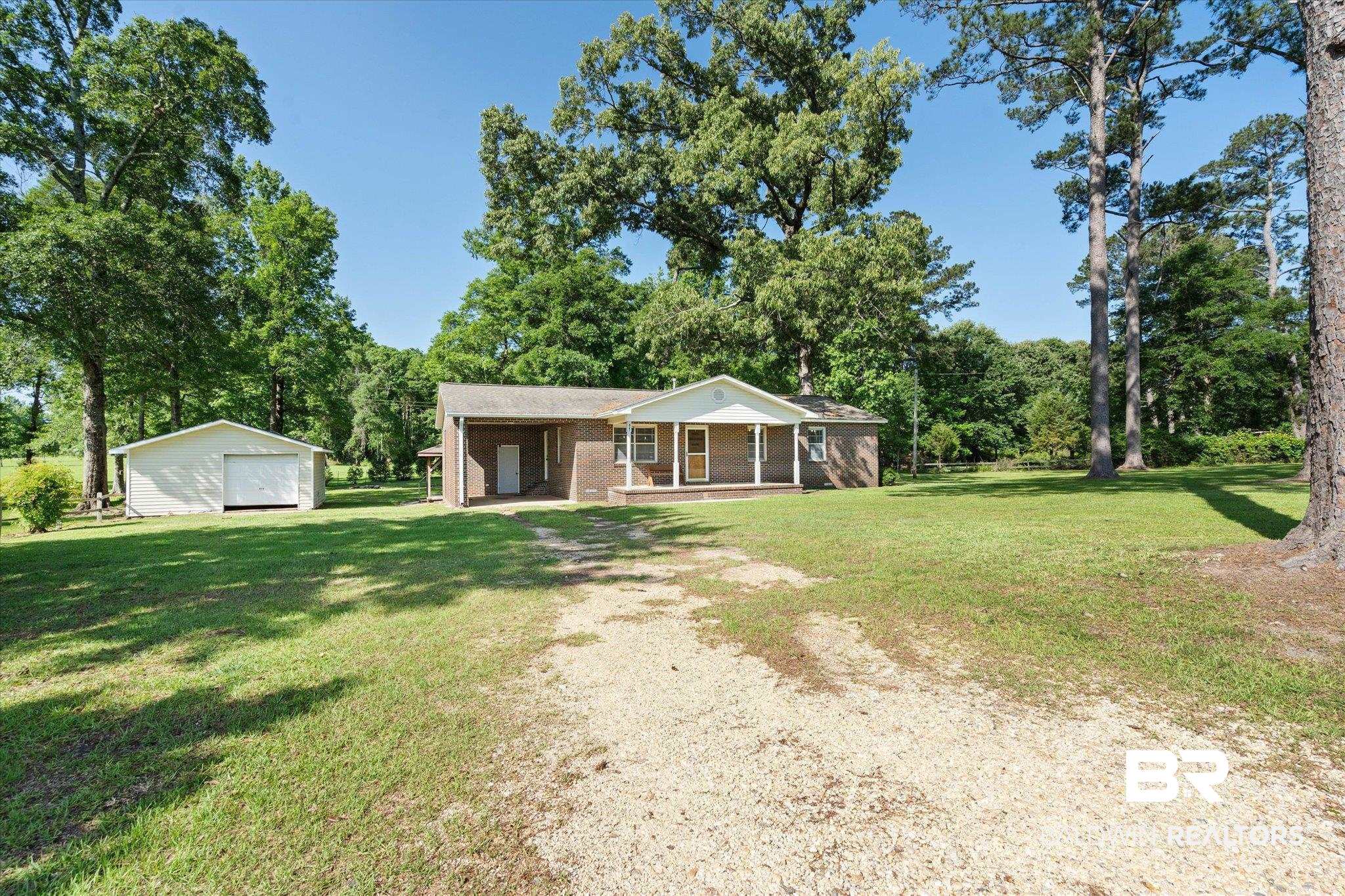 427 Upper Ferry Road Leroy, AL 36548 - Photo 22 of 37 Ranch-style house with driveway, a detached garage, a front yard, a porch, and an outbuilding
