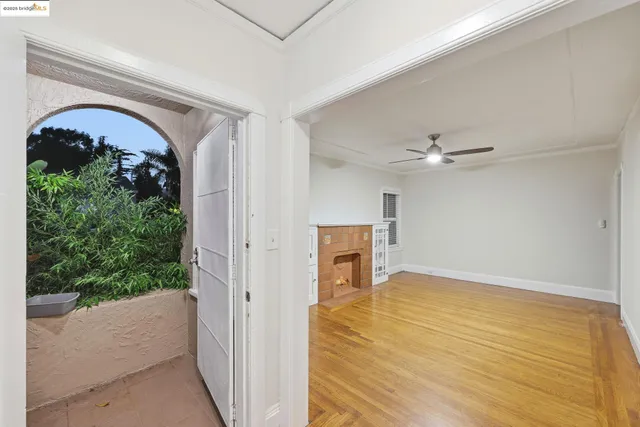 a view of empty room with a fireplace and a window