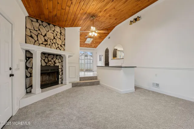 a view of an empty room with a fireplace