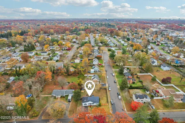an aerial view of residential building and trees around